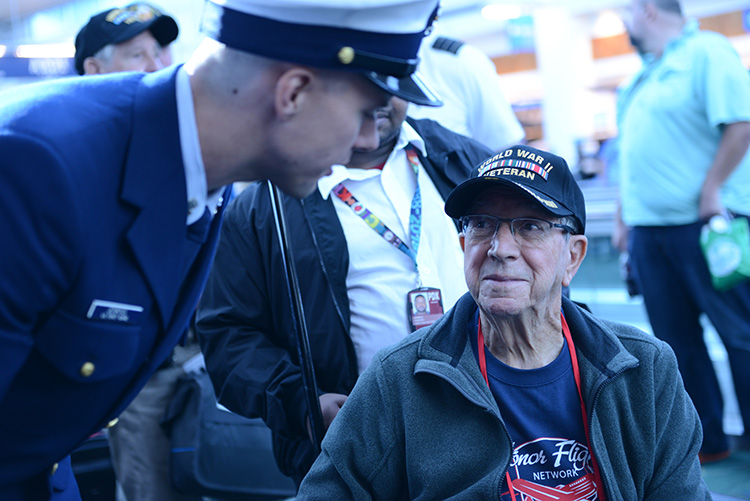Coast guardsman talking to a veteran