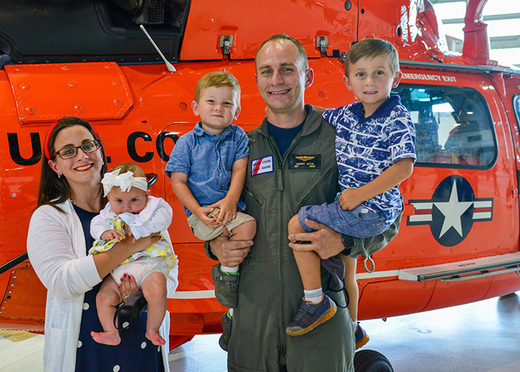 Coast guard airman with family. Wife and 3 children