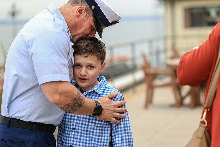Coast Guardsman hugging his son