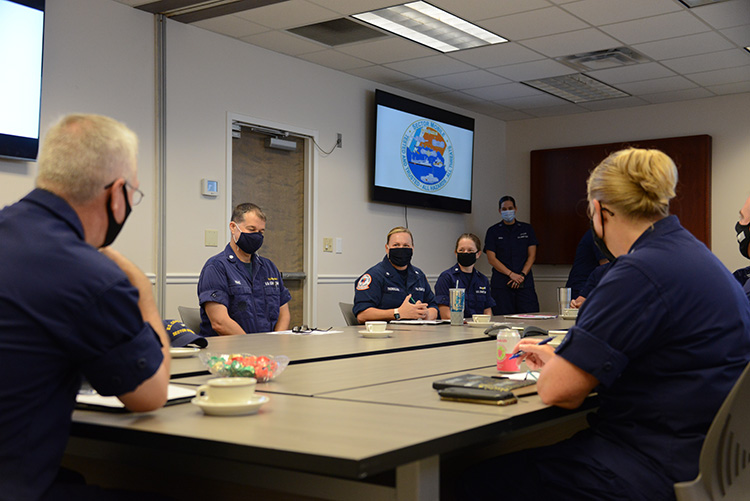 Coast guardsmen sitting around a table