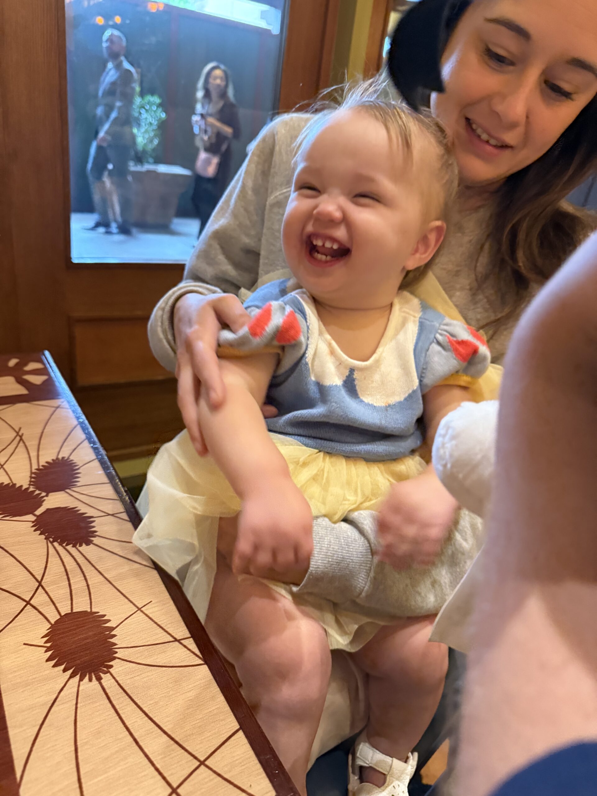 A smiling child laughs with family during the CGMA Open weekend. 