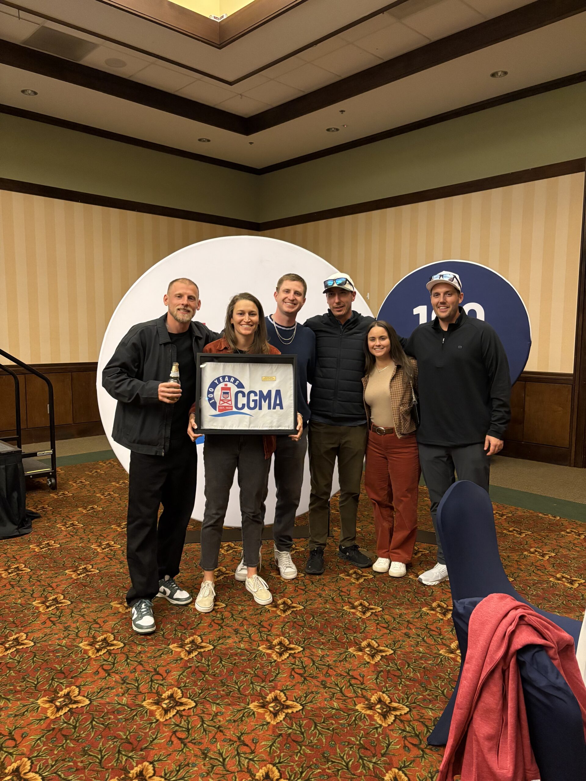 Lt. Casey Rude gathers with friends and fellow Coast Guard community members during the CGMA Open, an annual event supporting Coast Guard families.
